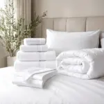 Stacked white towels and bedding