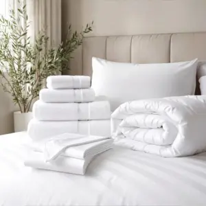 Stacked white towels and bedding