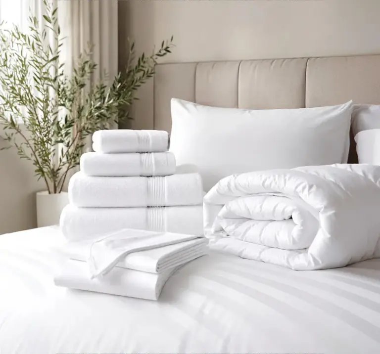 Stacked white towels and bedding